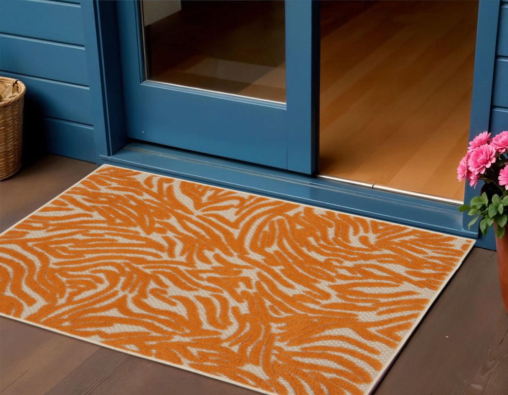 4' X 6' Orange And Ivory Abstract Stain Resistant Indoor Outdoor Area Rug