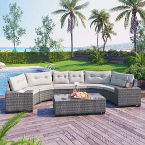 An 8-piece outdoor wicker round sofa set with a half-moon sectional and gray cushions sits on a wooden deck. A rectangular coffee table holds snacks and drinks. Palm trees, hedges, and a swimming pool enrich the scene with views of water and distant mountains in the background.
