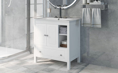 A modern bathroom with a solid wood vanity cabinet and ceramic sink, featuring towels and a drawer. Above is a round mirror, shelf with towels. The light gray tiled walls are bathed in sunlight, casting floor shadows.