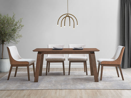 A modern dining room showcases the Ginny 5 Piece Dining Room Set in walnut with four cushioned chairs. Two small plates are placed on the table, beneath a contemporary gold chandelier. The room is decorated with a potted plant, light gray walls, and a gray curtain.