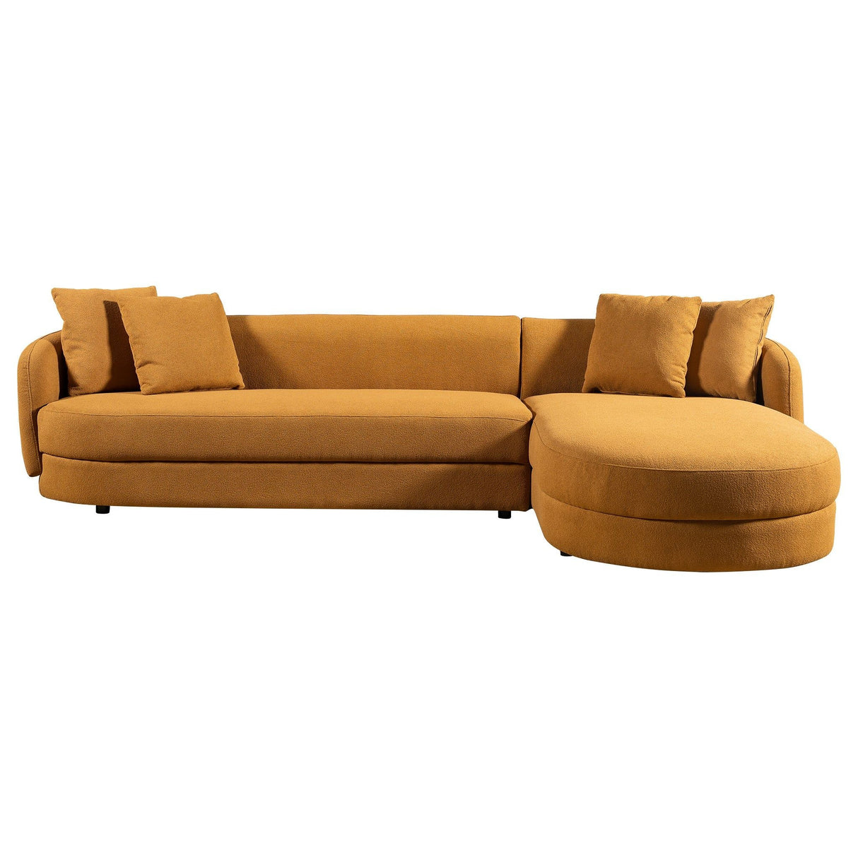 The Chandler Comfortable Sectional Sofa is a mustard yellow L-shaped design with four matching cushions, featuring a round chaise lounge on the right and minimalist style dark legs.