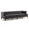 The Dylan Sofa by Four Hands is a contemporary black leather piece featuring a tufted design with deep button detailing and squared armrests. It rests on a wooden base with short legs and is showcased against a plain white background.