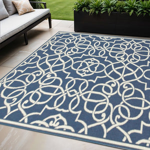 5' X 8' Blue and Ivory Geometric Stain Resistant Indoor Outdoor Area Rug