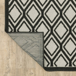 2' X 7' Beige and Black Geometric Stain Resistant Indoor Outdoor Area Rug