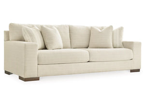 The Maggie Sofa is a beige fabric piece with two large seat cushions and multiple back cushions. It features dark wooden legs, boasts a modern design, and includes four coordinating throw pillows.