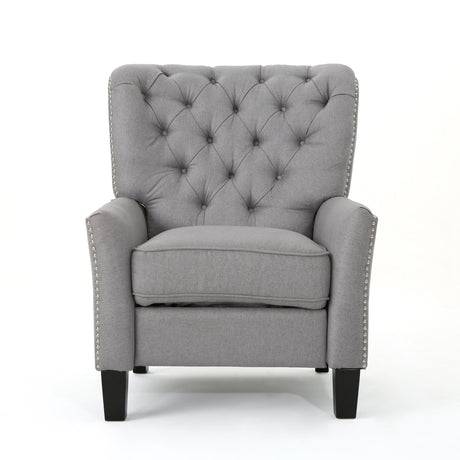 The Modern Push Back Recliner is a gray, tufted armchair with decorative buttons and nailhead trim. It has a cushioned seat, high back, and dark wooden legs, set against a plain white background.