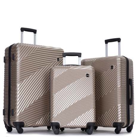 Three metallic gold suitcases with a diagonal stripe pattern and four spinner wheels are shown. Each suitcase features black top and side handles, along with extended telescopic handles, displayed side by side on a white background.