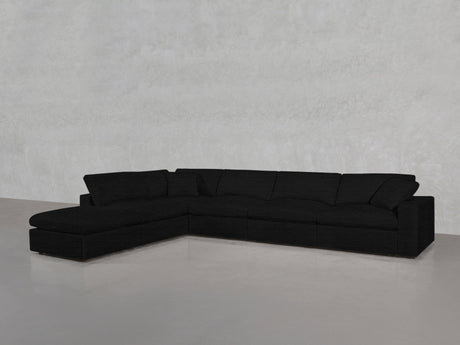 The 6-Seat Modular Corner Lounger Sectional in black features a left-facing chaise, set against a light gray textured wall and a smooth, reflective floor.