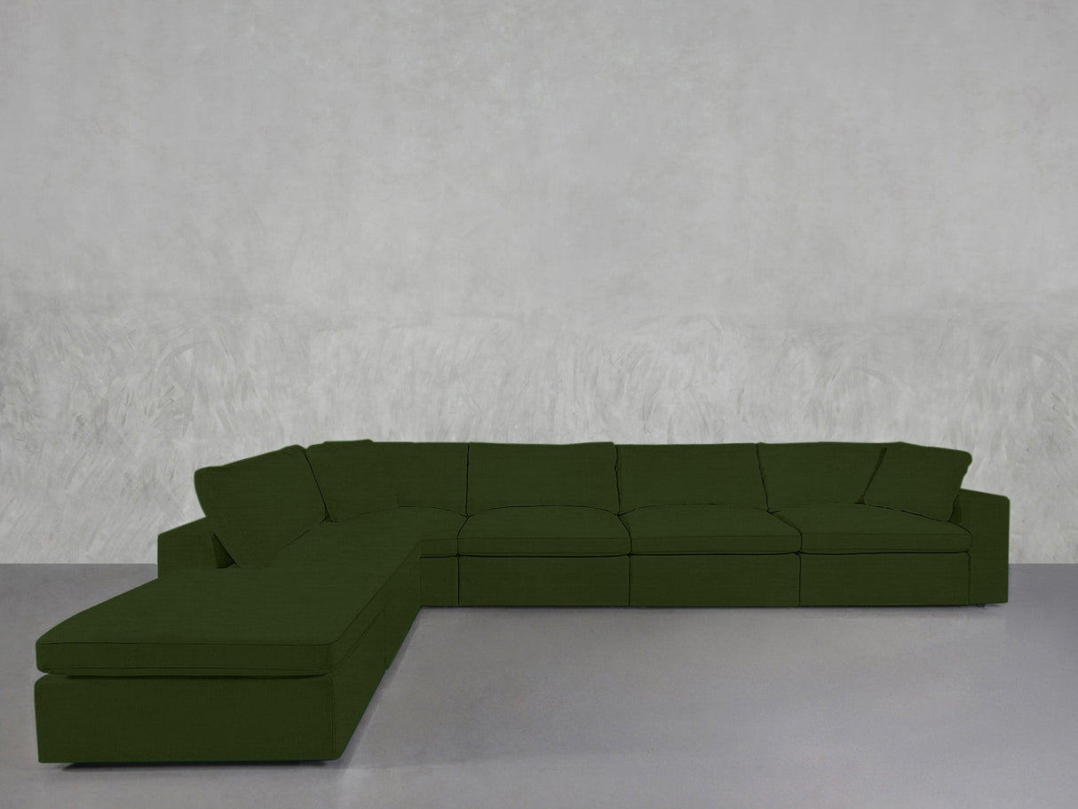 A 6-Seat Modular Corner Lounger Sectional in dark green fabric sits against a plain, light gray textured wall on a smooth, light gray floor.