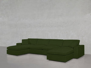 A 6-Seat Modular Double Chaise Sectional in green is placed against a plain, light gray wall and floor.