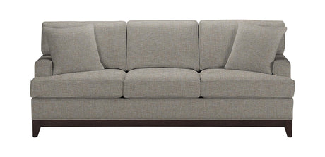 The Arcata Sofa, Quick Ship is a gray upholstered sofa featuring three seat cushions and three back cushions. It comes with two matching throw pillows placed on either side and has dark wooden legs.