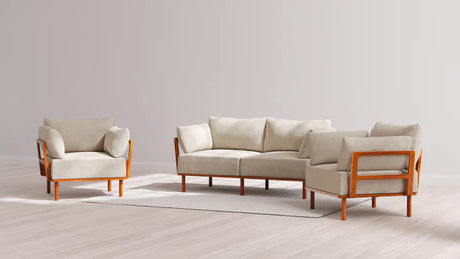 The Indoor Jack 2-Seater Sofa + Armchair Set in Balsa showcases a modern living room arrangement with a beige sofa and matching armchairs. These pieces rest on a light-toned rug within a minimalist environment, complemented by neutral-colored walls and flooring.