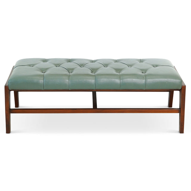 A Hera bench in antique/light sage green with a wooden frame from the front, featuring a tufted leather rectangular seat with visible stitching and classic minimalist design.