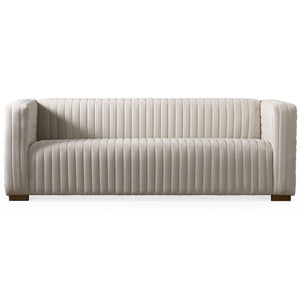 The Elara Upholstered Sofa features a modern white design with vertical tufted lines, wooden legs, straight arms, and backrest. Its low-profile build offers a sleek look perfect for a contemporary living room.