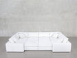 An 8-Seat Modular Closed Pit sectional in modern white, with four matching cushions, set against a light gray wall and polished concrete floor.