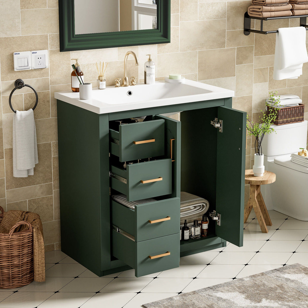 A bathroom features a Ceramic Sink Combo with a freestanding vanity set, three drawers, and soft-closing doors. The decor includes beige tiled walls, patterned white tile floors, a wicker basket, towel rack, round mirror, and toilet.