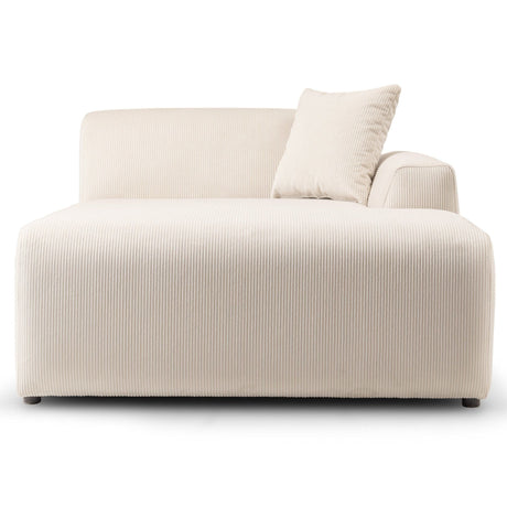 The Mar High-Quality Sectional Sofa is a modern white chaise lounge with a ribbed texture, featuring a left armrest and matching pillow. Its minimalist and elegant design is subtly elevated by small black legs.