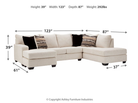 The Cambri 2-Piece Sectional with Chaise is a beige L-shaped sofa that comes with five cushions: two black and three patterned ones. It has dimensions of 39" in height, 123" in width, 87" in depth, and weighs 292 lbs.