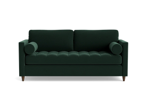 The Briar Sleeper Sofa is a dark green, mid-century modern piece featuring two cylindrical arm cushions and tufted seating. It is elevated on short wooden legs and presented against a plain black background.