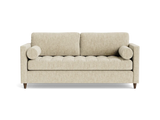 The Briar Sleeper Sofa, featuring a beige finish with a tufted seat, two rectangular back cushions, and cylindrical bolster pillows on either side, is set against a black background.