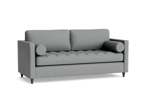The Briar Sleeper Sofa, a contemporary gray fabric piece featuring two back cushions, two bolster pillows, and wooden legs against a black background, showcases a textured, tufted seat design.