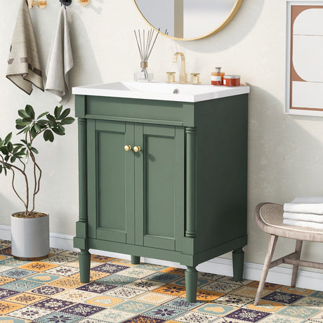 A bathroom features a Bathroom Vanity With Top Sink with gold knobs beneath a round mirror. The countertop displays hygiene products and a reed diffuser. Patterned floor tiles, a towel rack with towels, and a potted plant add greenery to the space.