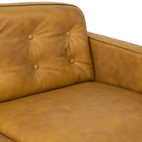 Close-up of a Braxton Tan Sofa, showcasing its angular armrests, tufted backrest with two buttons, and matte-finished smooth texture with a cushioned seat.