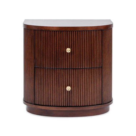 The Valentine 2 Drawer Storage Side Table is a rounded wooden nightstand with a dark brown finish and vertical grooves. It features two drawers, each with a simple round gold knob, offering a sleek and modern design.