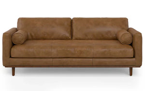 The Morrison 89-Inch Sofa and Ottoman Set in Genuine Leather showcases a modern design with its brown leather upholstery. It includes two seat cushions, two back cushions, and features two cylindrical bolster pillows on the arms. The sofa elegantly stands on wooden legs.