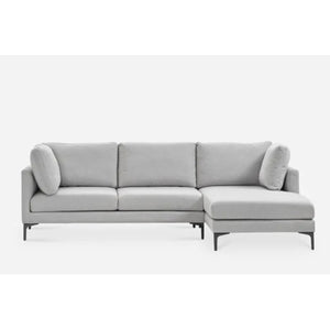 A modern L-shaped light gray sectional sofa with three seat cushions, an attached chaise on the right side, and two cylindrical throw pillows. The sofa has a minimalist design with slender black legs, set against a plain white background.