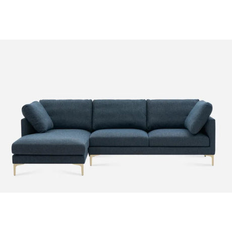 Dark gray sectional sofa with three seat cushions and two back cushions, featuring a chaise on the left side. The sofa rests on sleek, metallic legs, giving it a modern appearance. The background is plain white.