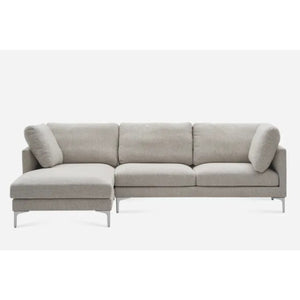 A modern L-shaped gray sofa with cushioned seats and backrests on a white background. It has sleek, metallic legs and two additional pillows on either end.
