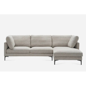 A modern gray sectional sofa with a chaise lounge on the right side. It has minimalist design and clean lines, featuring plush cushions and black legs, set against a plain white background.