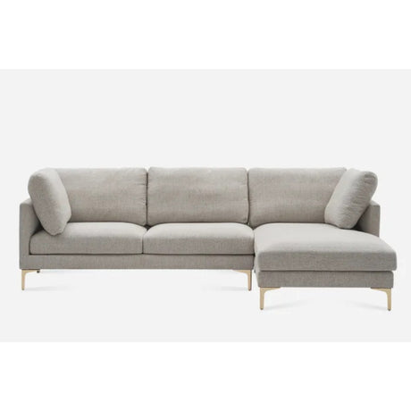 A light gray sectional sofa with a right-hand chaise lounge. The sofa has three cushions on the left side and a single cushion on the chaise. Wooden legs provide support, and the sofa has a minimalist design.