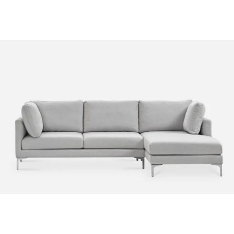 A modern, light gray sectional sofa with three cushioned seats and a right-side chaise lounge. It features metal legs and comes with matching side pillows, set against a plain white background.