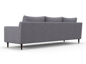 The Alex Sofa is a contemporary piece with a minimalist design, featuring three cushions and a low backrest. It stands on dark, tapered wooden legs, presenting a sleek modern look when viewed from the back at an angle.