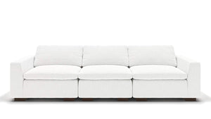 A sleek, minimalist 106" Like Butter sofa in luxurious Enzo/Cream leather, featuring plush cushions and blocky wooden legs, set against a plain white background.