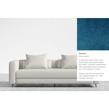 A contemporary Berlin Sleeper Sofa in white, accompanied by four cushions set against a white background. In the upper right corner, there is a close-up swatch of plush blue velvet fabric described as luxurious and possessing a muted sheen.