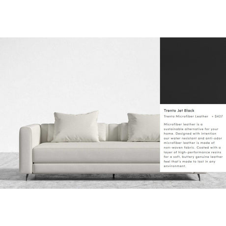 The Berlin Sleeper Sofa is a modern piece in light gray, featuring two large cushions against a minimalist backdrop. Made from sustainable Trento microfiber leather and designed for durability, it is priced at $427.