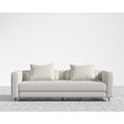 The Berlin Sleeper Sofa, in a sleek light gray, comes with two matching cushions and is positioned on a textured gray area rug against a plain white wall, showcasing its design with clean lines and minimalist aesthetic.