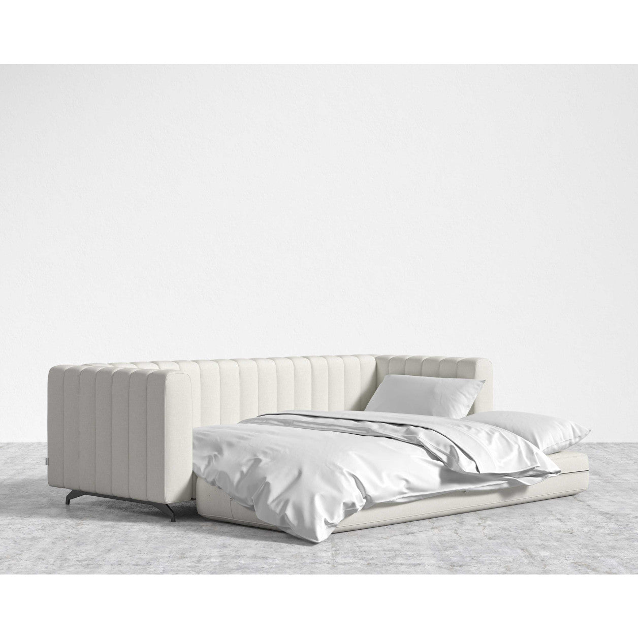 The Berlin Sleeper Sofa, a white convertible with a ribbed backrest, is displayed against a plain white background. It's styled with white bedding and pillows and positioned on a light gray floor.