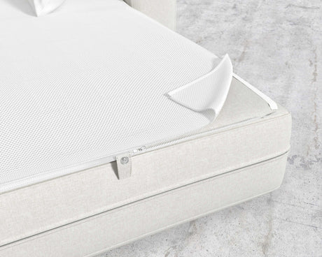 The image features a close-up of a white zippered cover, partially open to reveal the mesh inner layer beneath. This Berlin Sleeper Sofa rests on a light-colored fabric bed base set against a concrete-looking floor.