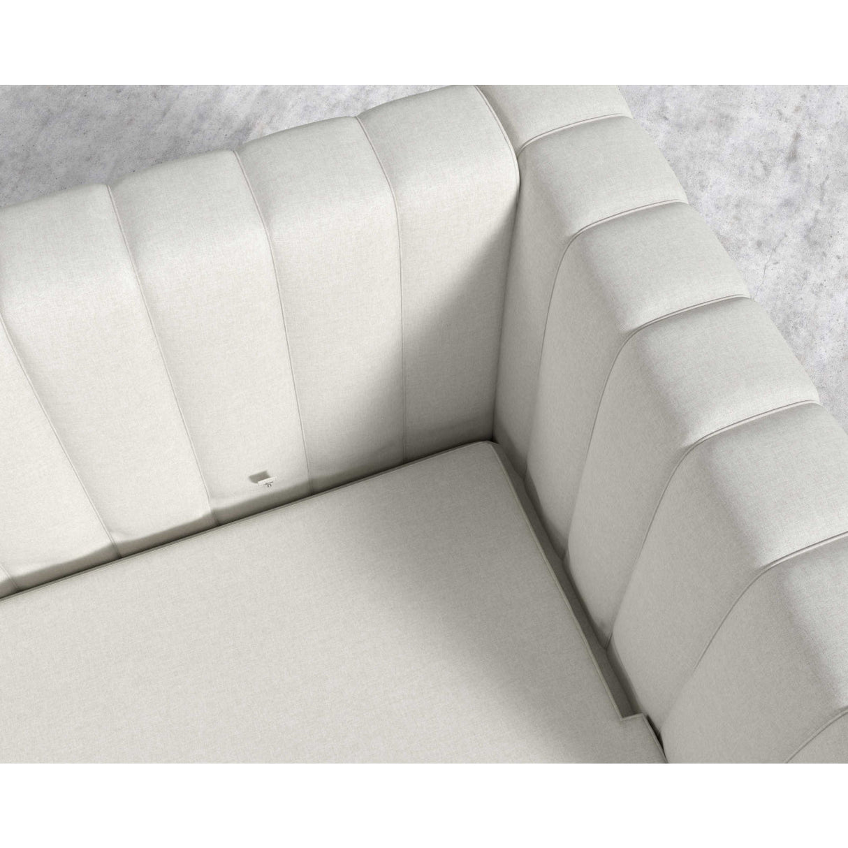 Introducing the Berlin Sleeper Sofa, featuring a white, tufted corner section with luxurious soft upholstery. Its quilted pattern on the backrest and seat enhances its plush appearance. Beneath this modern sofa, a portion of light-textured flooring is visible.