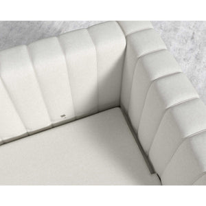 Introducing the Berlin Sleeper Sofa, featuring a white, tufted corner section with luxurious soft upholstery. Its quilted pattern on the backrest and seat enhances its plush appearance. Beneath this modern sofa, a portion of light-textured flooring is visible.
