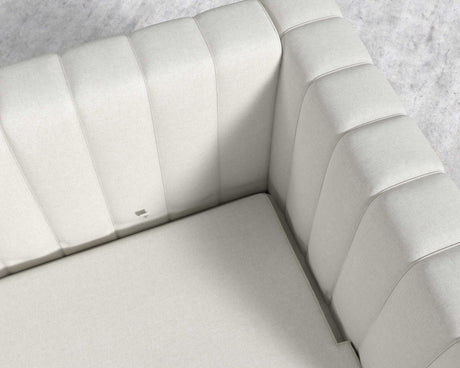 Top view of the Berlin Sleeper Sofa in light gray, featuring modern upholstery. The cushions display vertical stitching and the fabric looks smooth and soft. It is set on a light-colored textured floor.