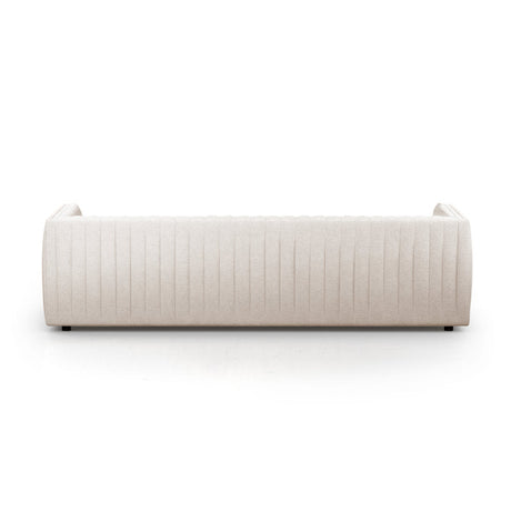The Brandt 97'' Upholstered Sofa in beige, featuring a modern design with a quilted pattern on the backrest, is displayed from the back against a white background. The sofa boasts a sleek, rectangular shape complemented by slightly rounded armrests.
