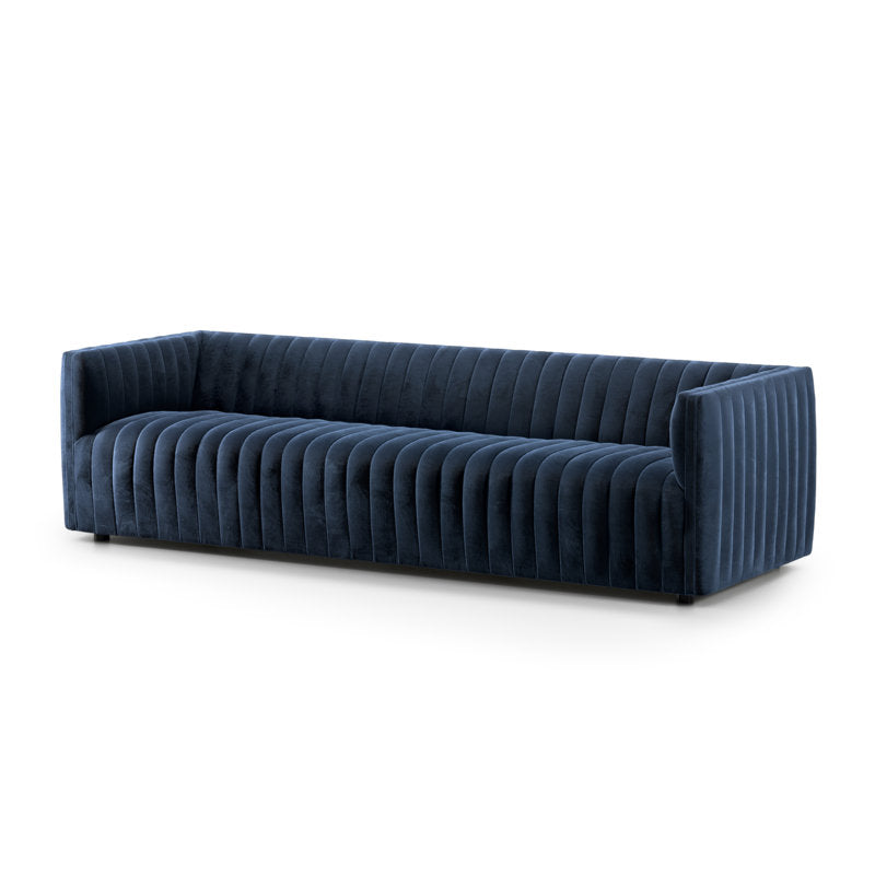 Introducing the Brandt 97'' Upholstered Sofa: a spacious, modern design featuring luxurious deep blue velvet upholstery. This rectangular sofa stands out with its vertical stitching on the back and sides, offering a sleek and contemporary aesthetic. It also boasts a low profile with hidden legs for a minimalist finish.