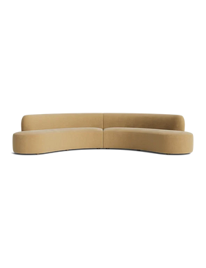 The Cara Sectional Sofa, featuring a minimalist design with its curved shape and tan color, is displayed against a black background.