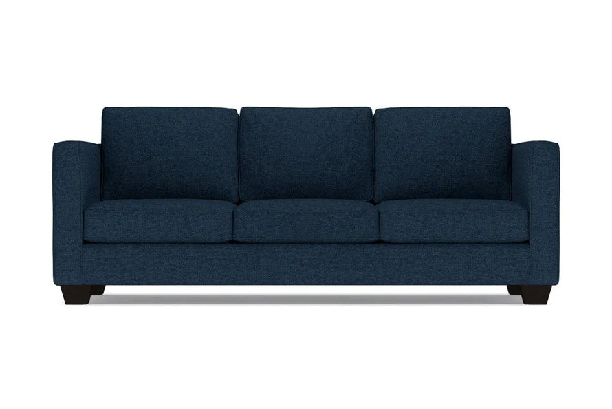 The Catalina Sofa is a dark blue, three-seater with a clean, modern design. It features three cushions and straight arms, set on short black legs, against a plain white background.
