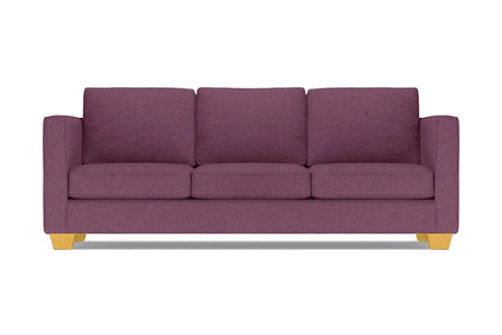 The Catalina Sofa, with its modern design in a purple hue, comes complete with three cushions. It features straight arms and light wooden legs, all showcased against a white background.